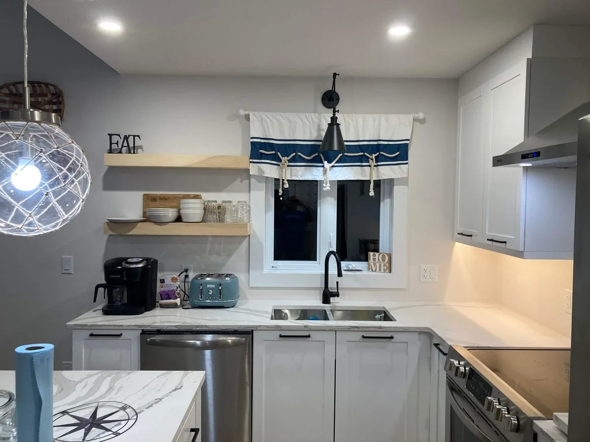 The kitchen sink wall with open shelves