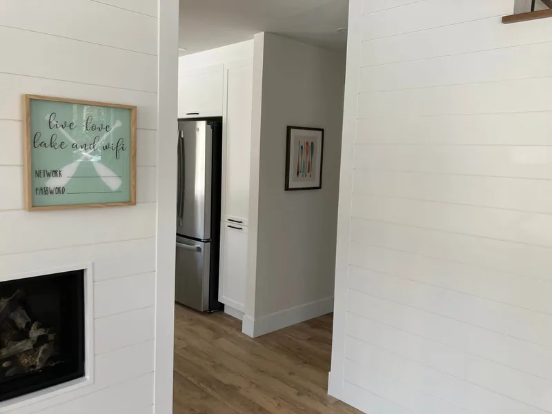 The shiplap wall with the opening of the three-sided fireplace