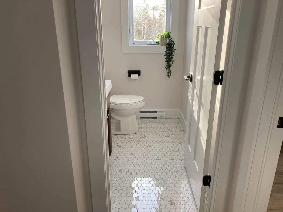 The main bathroom with its hex tile floor